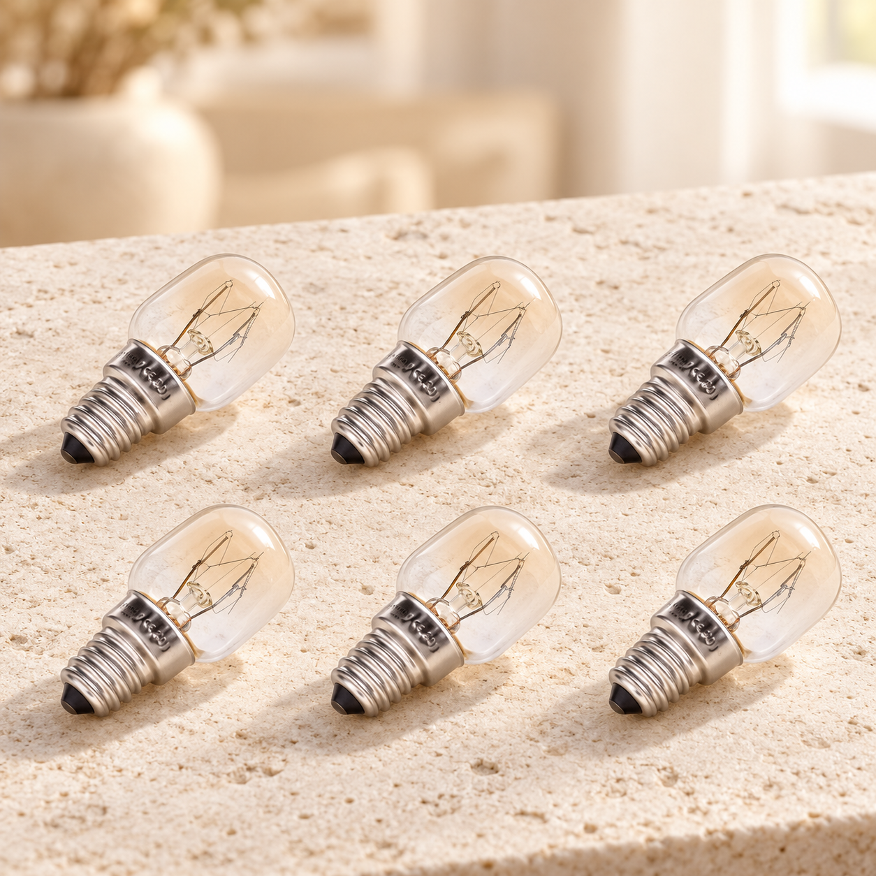 Six clear salt lamp replacement bulbs on a stone surface